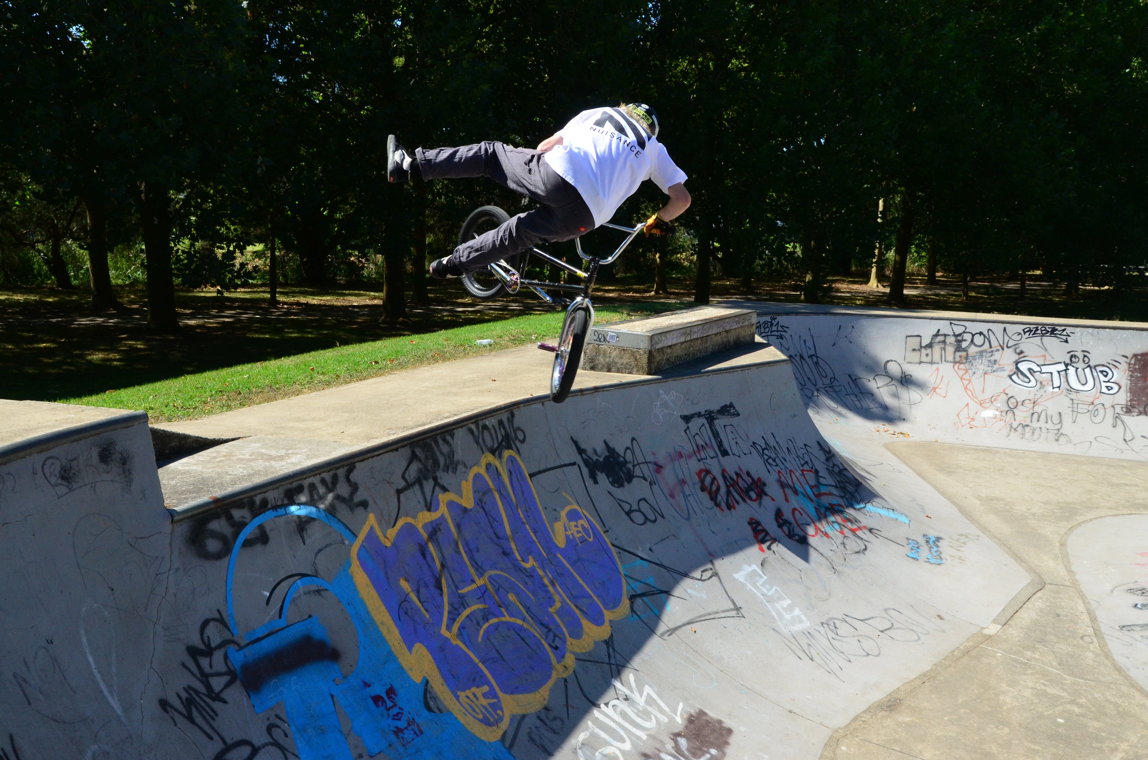 Mens Platinum tee worn by BMX rider doing a trick at skatepark