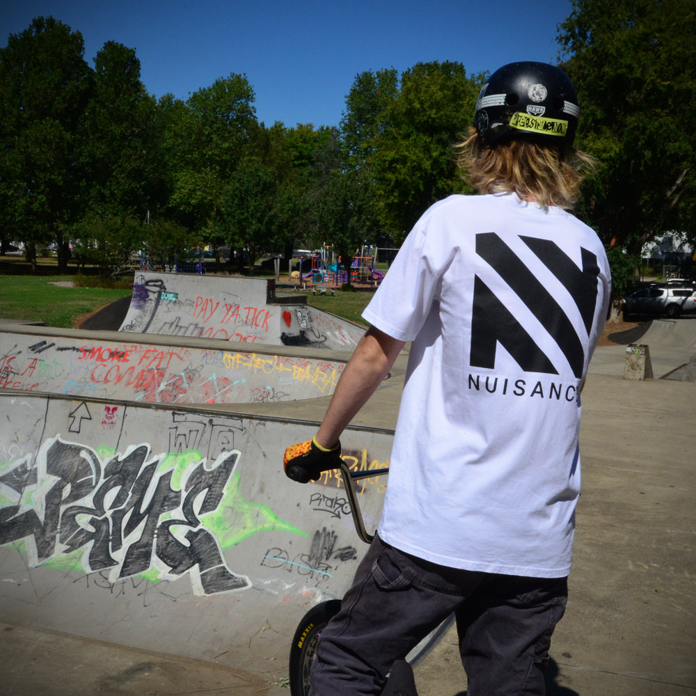 Mens Platinum Tee in white at skatepark on bmx